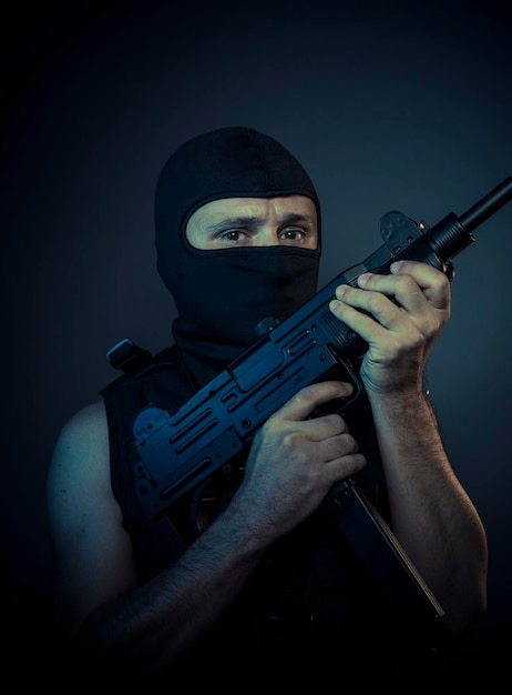 terrorist carrying a machine gun and balaclava