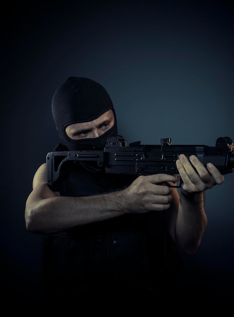 terrorist carrying a machine gun and balaclava