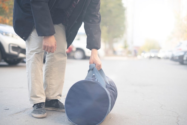 A terrorist holding bag with bomb inside to put it in the public place in the street