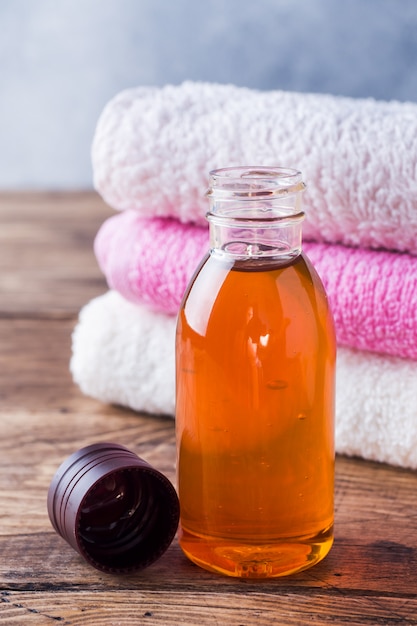 Terry towel and cosmetic oil for massage.