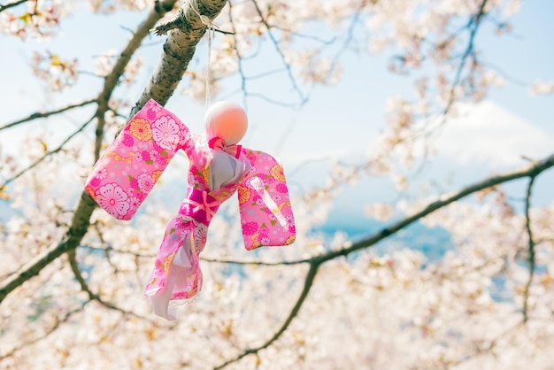 Teru Teru Bozu. Japanese Rain Doll hanging on Sakura tree to pray for good weather