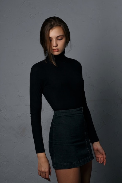 Test shooting for glorious young model wearing denim skirt and black sweater