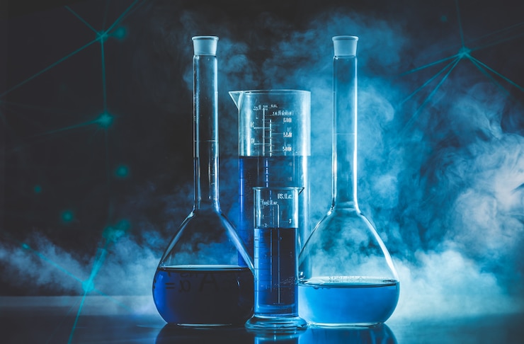 Photo test tube and flask with blue liquid and blue smoke. chemistry and laboratory concept.