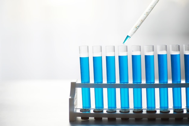 Test tube of glass overflows new liquid solution potassium blue conducts an analysis reaction takes various versions reagents using chemical pharmaceutics cancer manufacturing .