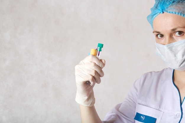 Test tubes in the hand of a laboratory technician. White background