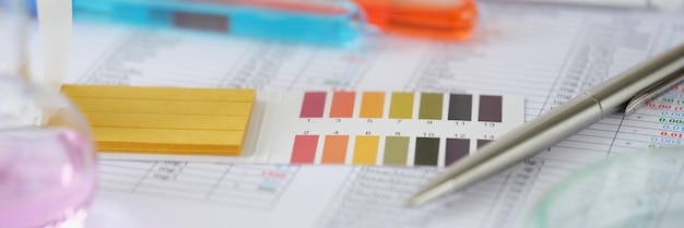 Photo test tubes with blue and orange liquid with test results on table laboratory research home