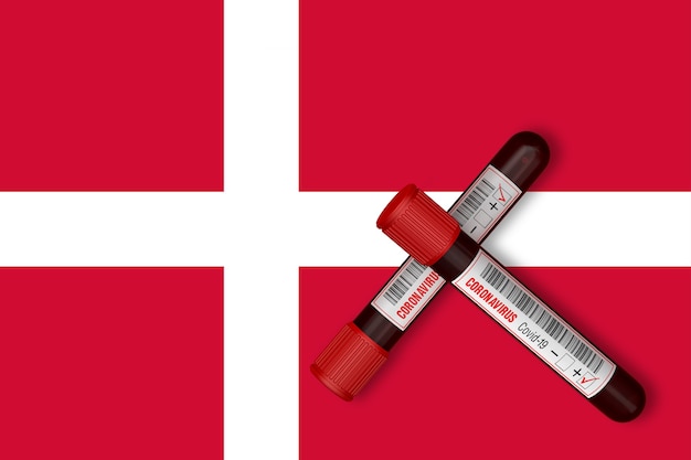 Test tubes with the Inscription 2019nCoV on the background of the Denmark Flag