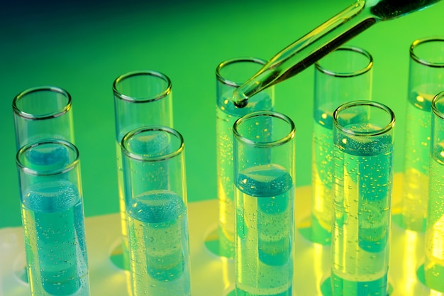 test-tubes with liquid on green
