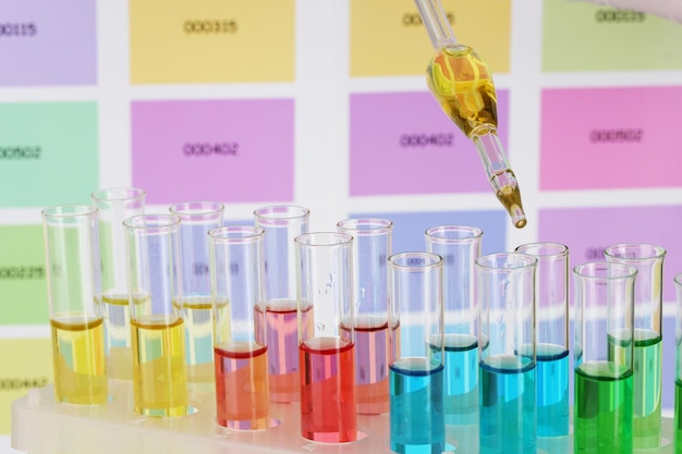 Testtubes with color liquid and pipette on color samples background