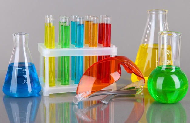 Testtubes with colorful liquids on gray background