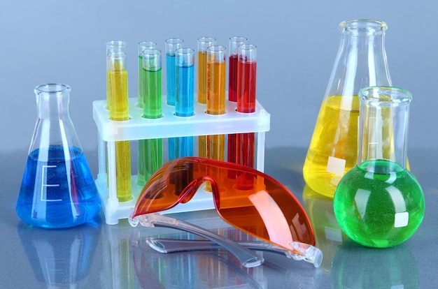 Testtubes with colorful liquids on gray background