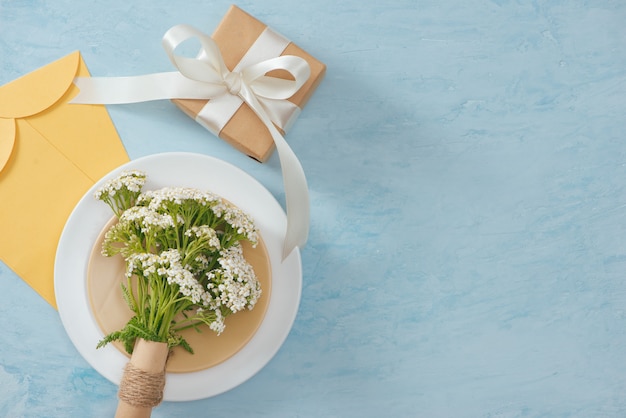 Tet vakantieconcept. Gouden envelop (geluksgeld) op tafel met tafel met plaat en bloemen.