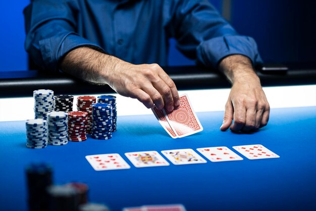 Texas hold 'em poker tournament at the casino a player is holding two cards piles of chips on the table