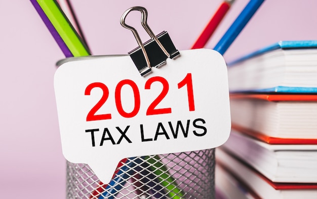 Text 2021 tax laws on a white sticker with office stationery space