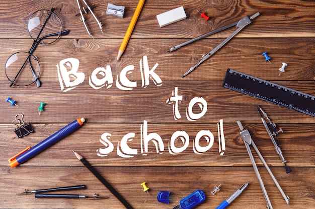 Text - back to school and student material on wooden table.