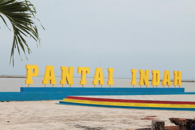 Text on beach against clear sky