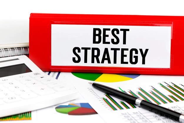 Text BEST STRATEGY on red folder. Business concept.
