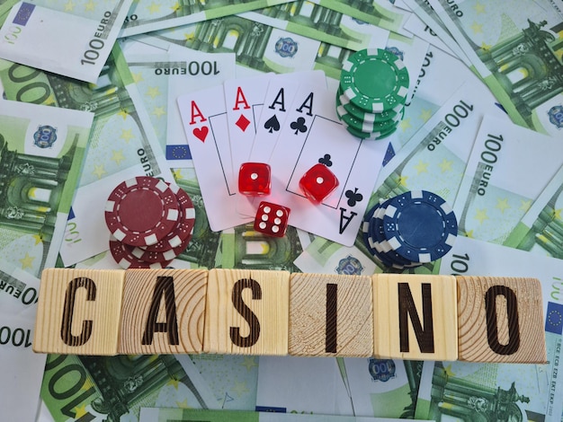 Text casino chips playing cards and dices on euro banknotes