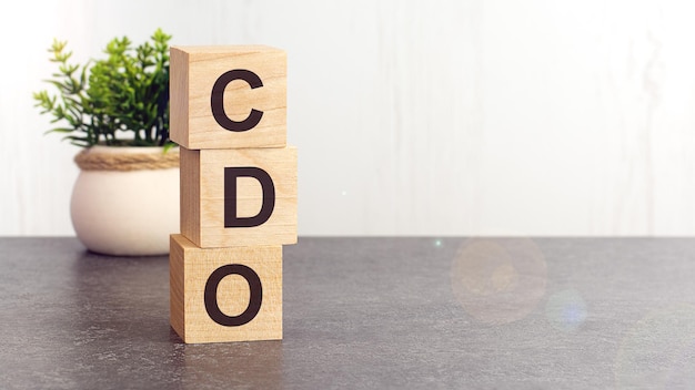 Text CDO on wooden dice standing on top of each other