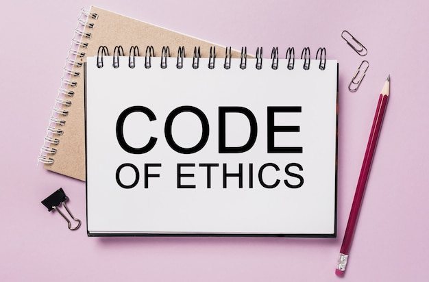 Text Code of Ethics on a white notepad with office stationery space