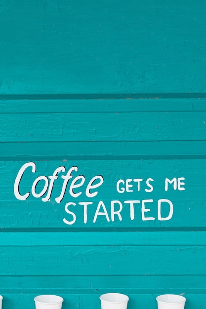 Photo text coffee gets me started on a wooden turquoise background