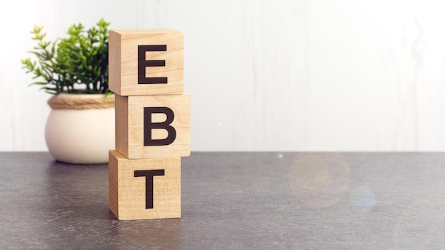 Text EBT on wooden dice standing on top of each other