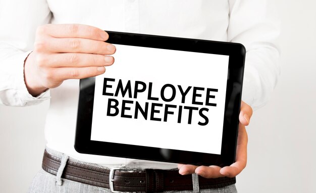 Photo text employee benefits on tablet display in businessman hands on the white background business concept