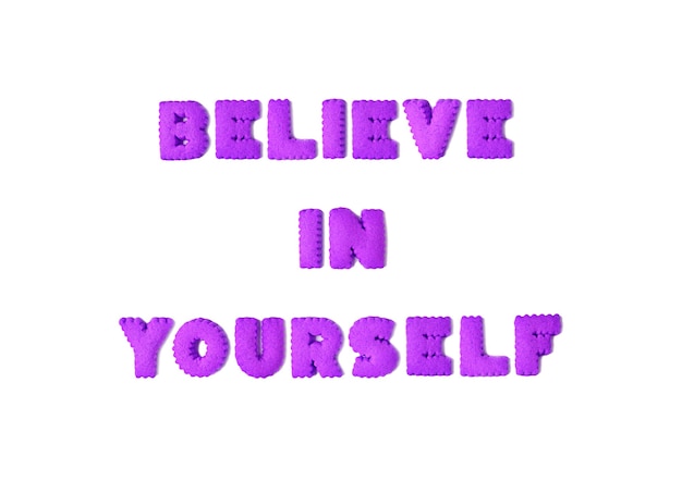 Text of encouragement spelled with purple alphabet shaped cookies on white background