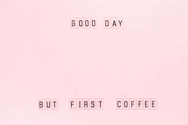 Text Good day, but first coffee on pastel pink paper background. 