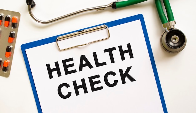 Text HEALTH CHECK in the folder with the stethoscope