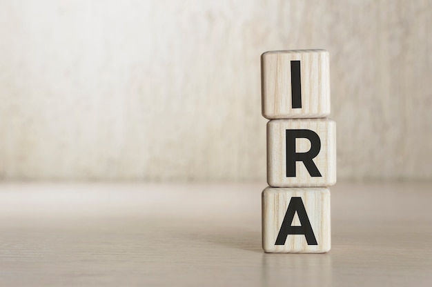 Photo text ira - individual retirement account on wooden blocks. business concept.