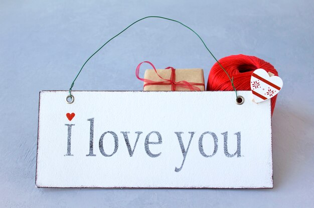 Photo text letters word gift, heart, red thread, valentine's day