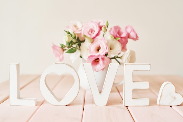 Text LOVE with beautiful flowers. Saint Valentine concept