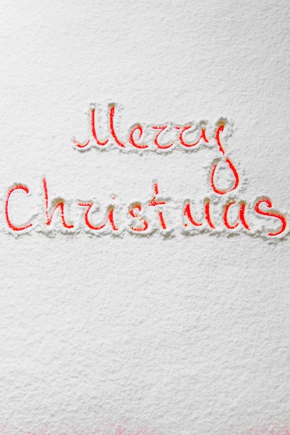 Text Merry Christmas on the snowy background