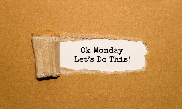 The text Ok Monday Lets Do This appearing behind torn brown paper
