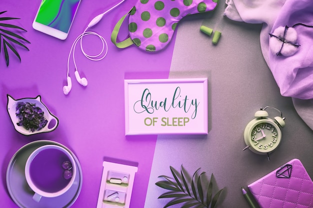 Text "Quality of sleep" in frame. Healthy sleep creative concept. Sleeping mask, alarm clock, earphones, earplugs, tea and pills.