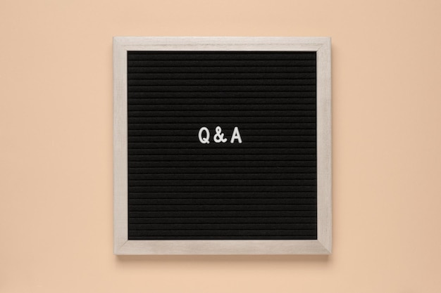 The text questions and answers on black letter board over isolated beige background