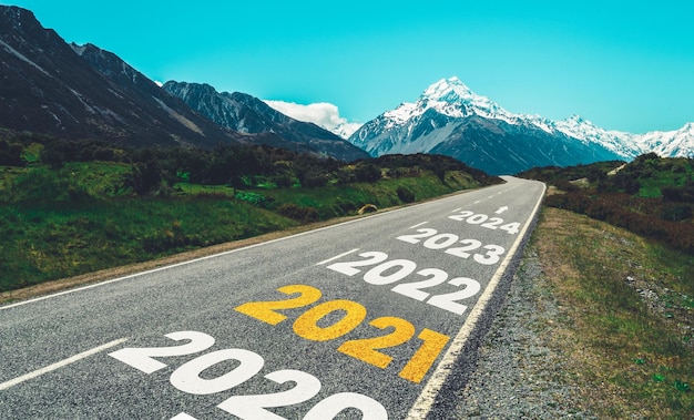 Text on road by mountain against sky