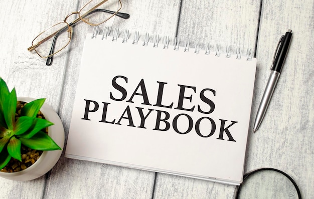 Photo the text sales playbook on paper notepad and calculator