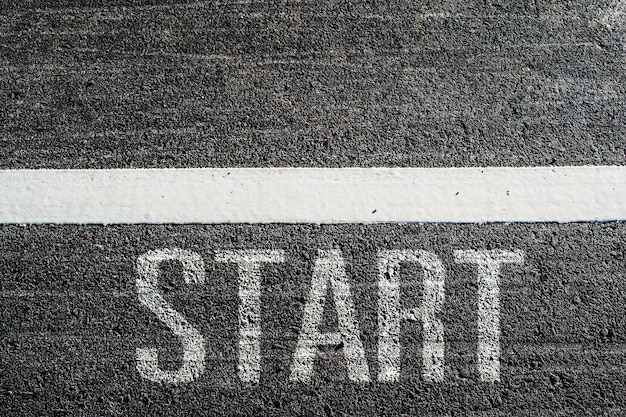 Text START written on an asphalt road