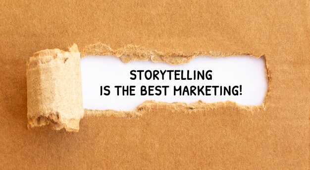 Text Storytelling is the best Marketing appearing behind torn brown paper,concept