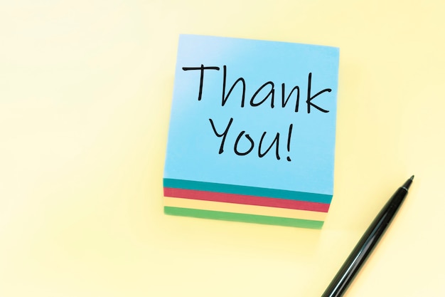 Text thank you on blue sticker on yellow background