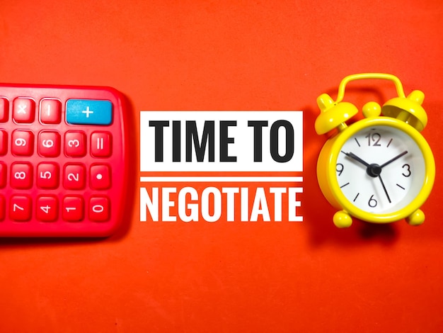 Text TIME TO NEGOTIATE with calculator and clock on red background