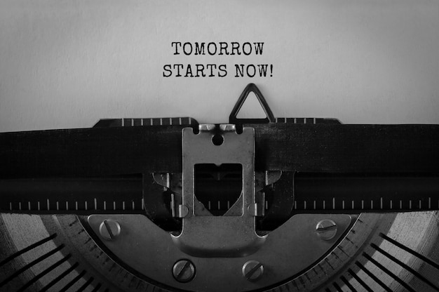 Text Tomorrow starts now typed on retro typewriter