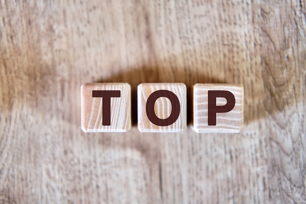 Text - Top on wooden cubes, on wooden background