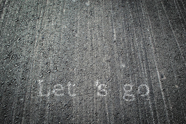 Text  written on an asphalt road