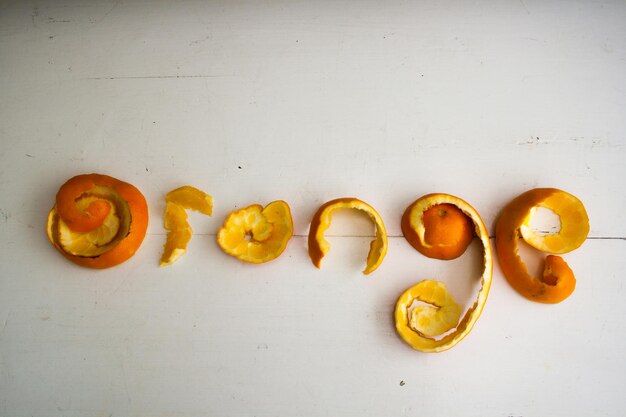 Photo text written by orange peel on white table