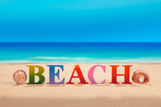 Photo text written on sand at beach against sky