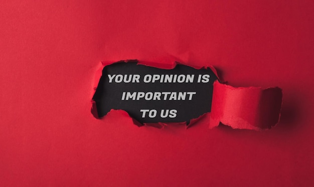 Text your opinion is important to us on a black background with red torn paper