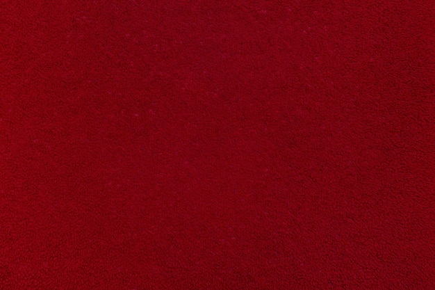 Foto textielachtergrond rood fluweel of corduroy een leeg en vlak oppervlak